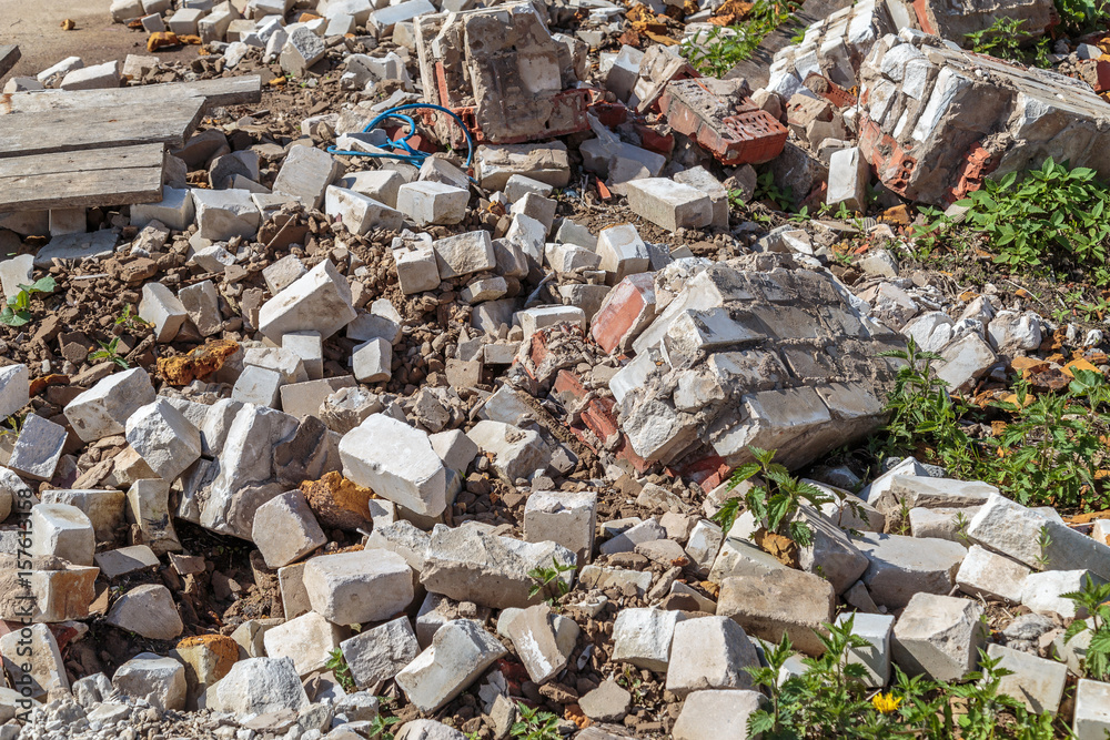 A pile of broken bricks and debris of various construction debris