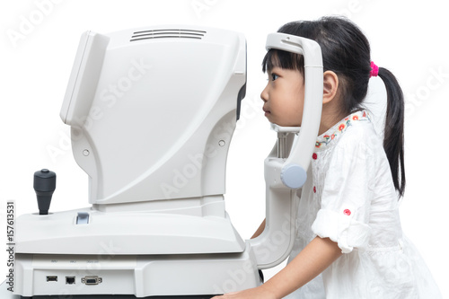 Asian Little Chinese Girl Doing Eyes Examination Through Auto refractometer
