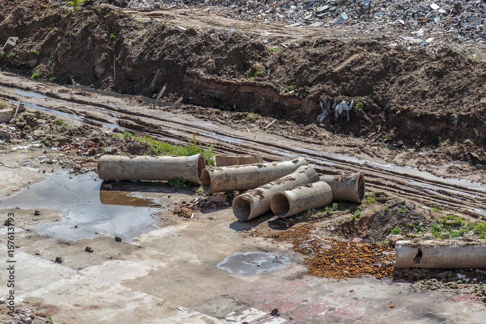 Hastily scattered pipes of the sewage collector Hastily scattered pipes of the sewage collector