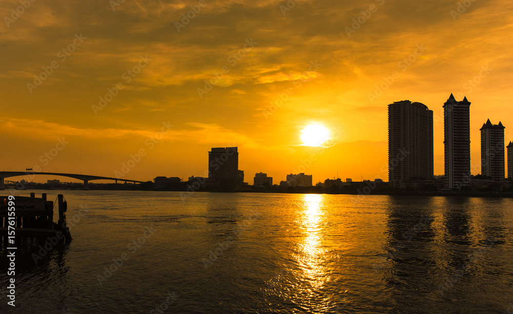 Bangkok City skyscrapers silhouette urban view silhouette of steel bridge over the Chao Phraya River,Bangkok, Thailand at sunrise.