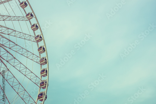 Fototapeta Naklejka Na Ścianę i Meble -  Vintage Retro Ferris Wheel Over Blue Sky in Bangkok,Thailand