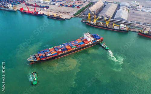 container ship in import export and business logistic.By crane ,Trade Port , Shipping, cargo to harbor, Aerial view, Top view. © MAGNIFIER