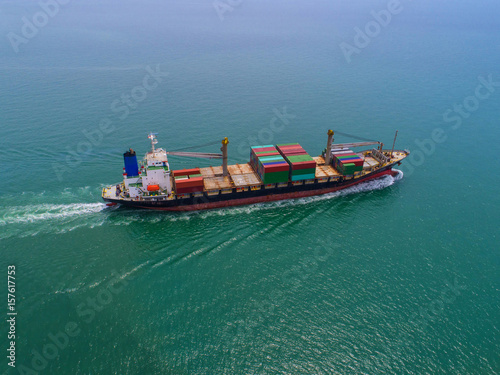 container ship in import export and business logistic.By crane ,Trade Port , Shipping, cargo to harbor, Aerial view, Top view.