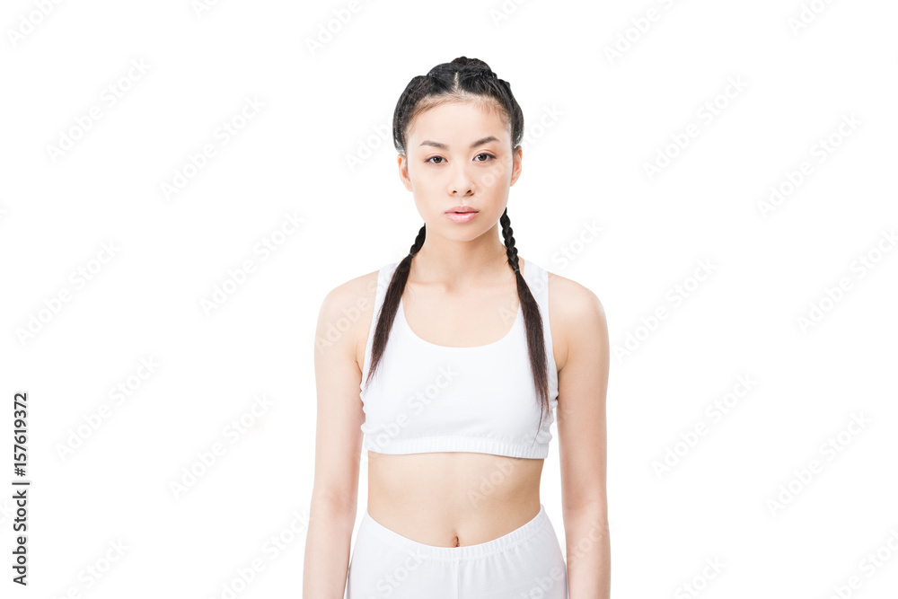 asian girl with braids in white sportswear looking at camera isolated on white asian girl with braids in white sportswear looking at camera isolated on white