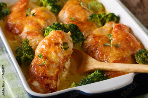 hearty Chicken fillet and broccoli baked in cheese sauce close-up. horizontal