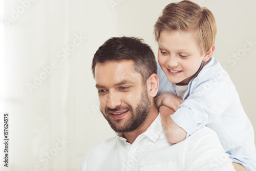 little son with young father spending time at home