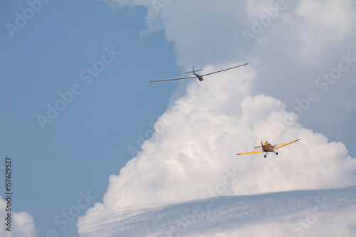 Plane pulling of a glider, a small sports plane pulls a glider into the cloud.