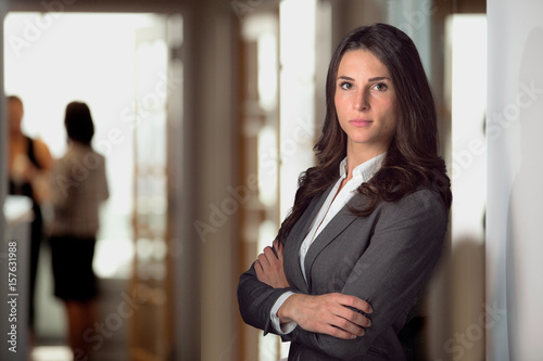 Fototapeta Strong female lawyer standing confident at office firm looking tough resilient w