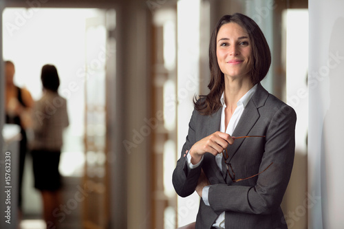 Candid portrait of a joyful cheerful happy employee staff member leader at the office workspace photo