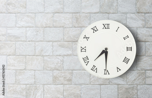 Closeup white clock for decorate show half past seven o'clock or 7:30 a.m. on old brick wall textured background with copy space in interior concept
