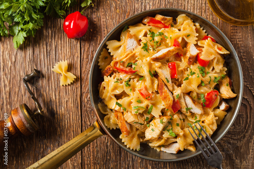 Pasta farfalle with chicken and paprika, in carbonara sauce.