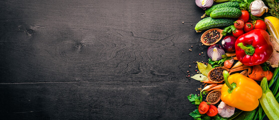 Frame of organic food. Fresh raw vegetables and spices. On a wooden chalkboard.