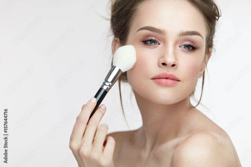 Facial Makeup. Beautiful Female Applying Blush With Brush