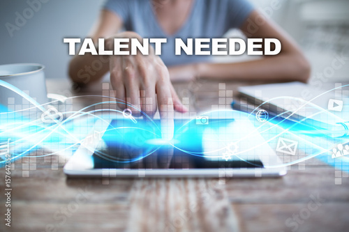 Woman using tablet pc, pressing on virtual screen and selecting talent needed.