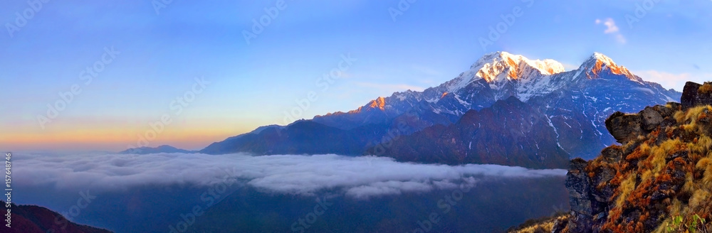 Mountain Landscape in Himalaya. Above clouds. Annapurna South peak.
