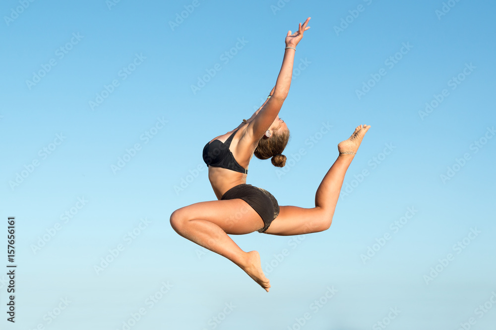 Girl jumping in the beach