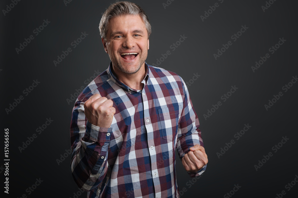 Enthusiastic cute guy supporting his team