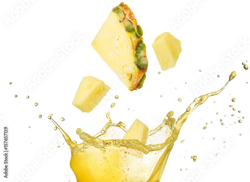 pineapple slice and pieces falling into yellow juice