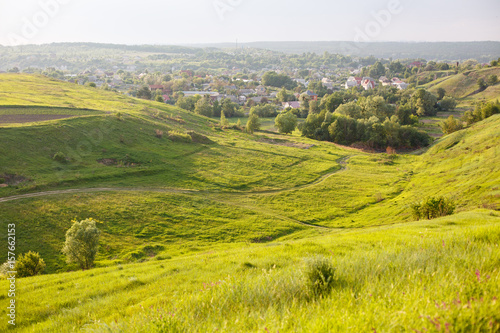 Summer or spring landscape with green hills or mountains and trees