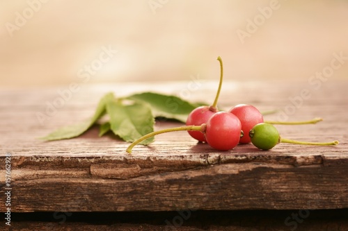 Flacourtiaceae / Indian plum on the old wooden floor and blurred background. photo