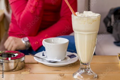 Young woman drinking coffee and milk shake  at the restaurant