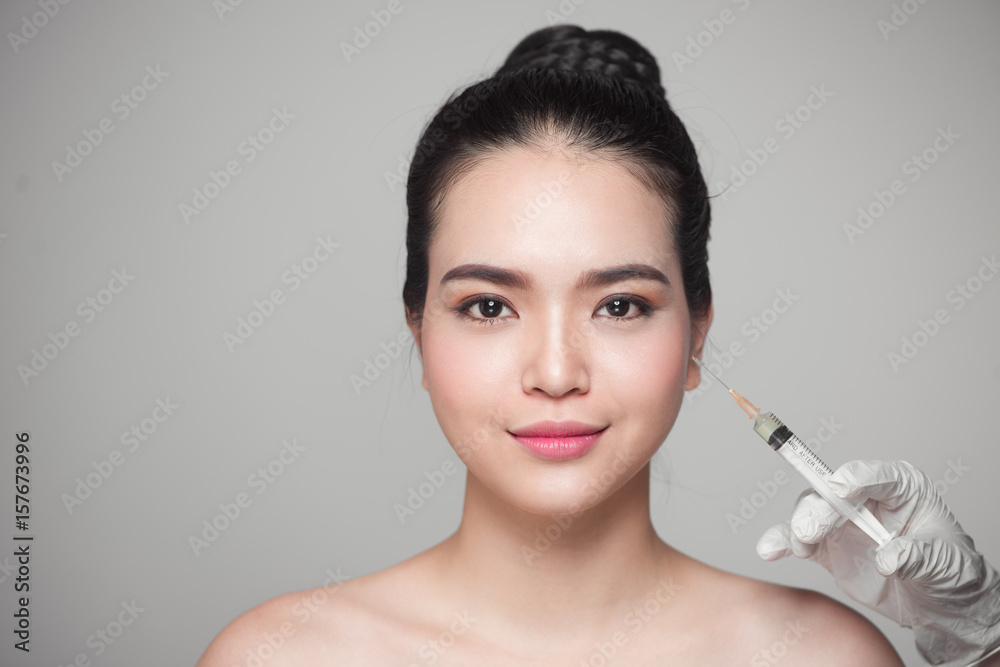 Asian Injection Mark Beautiful asian woman gets beauty facial injections. Face aging ...