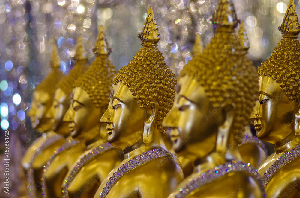 Fototapeta premium UTHAI THANI PROVINCE, THAILAND - August, 2016: Golden Buddha statue at Cathedral glass, Wat Tha Sung or Wat Chantharam