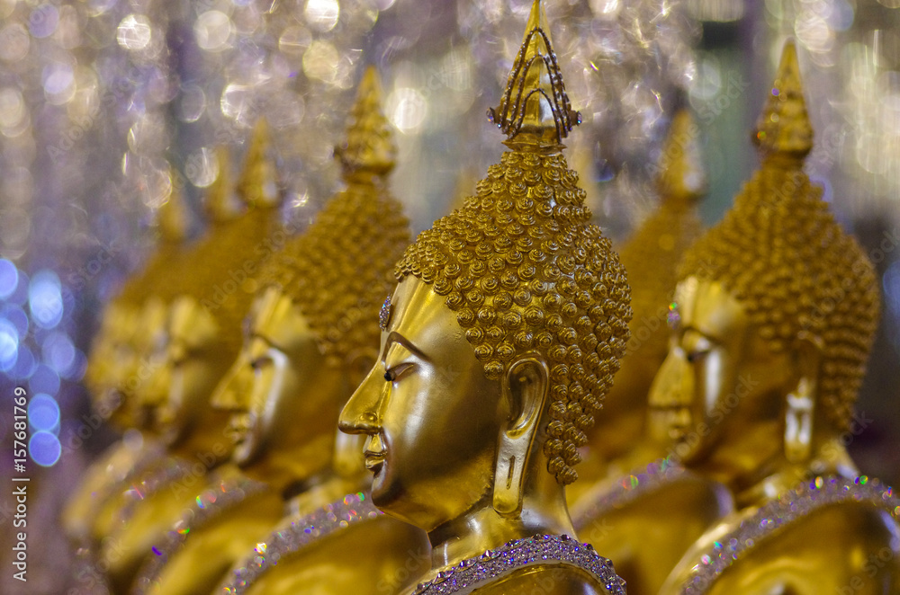 Fototapeta premium UTHAI THANI PROVINCE, THAILAND - August, 2016: Golden Buddha statue at Cathedral glass, Wat Tha Sung or Wat Chantharam