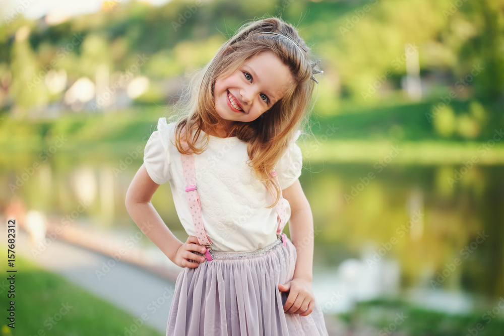 Naklejka premium cute little girl in summer park