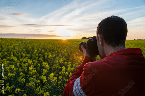 Photograper with camera in nature photo