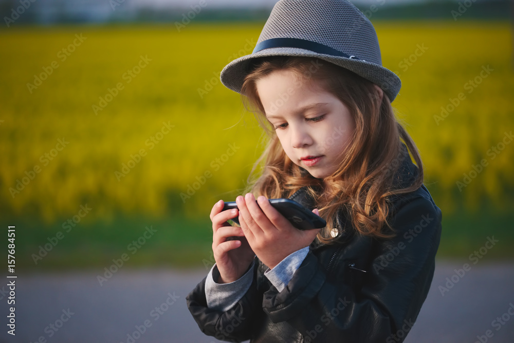 little funny girl with smartphone