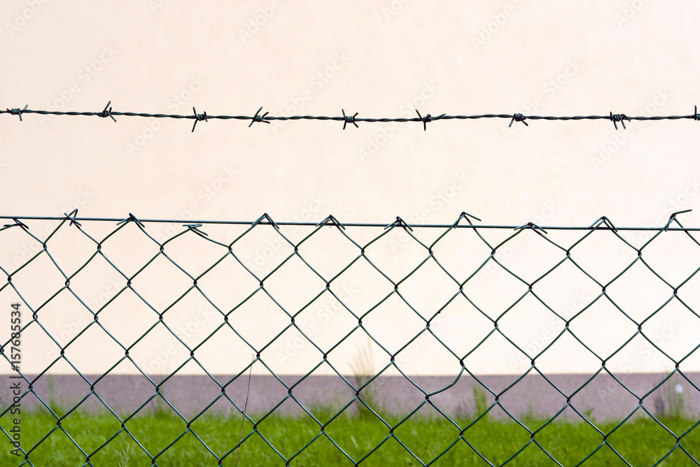 Barbed wire fence in front of the factory Barbed wire fence in front of the factory