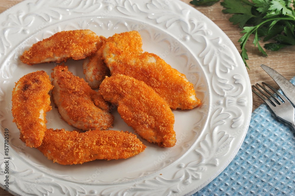 chicken nuggets in bowl on wooden background chicken nuggets in bowl on wooden background
