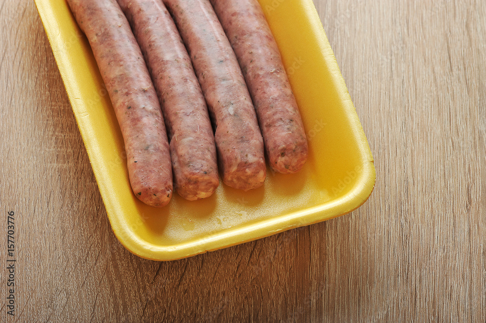 raw meat sausages kupaty in the yellow plastic tray raw meat sausages kupaty in the yellow plastic tray