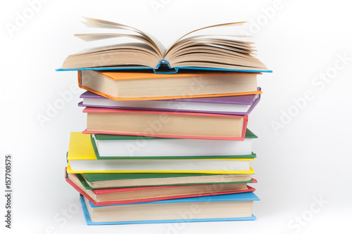 Book stacking. Open book, hardback books on white background. Back to school. Copy space for text.