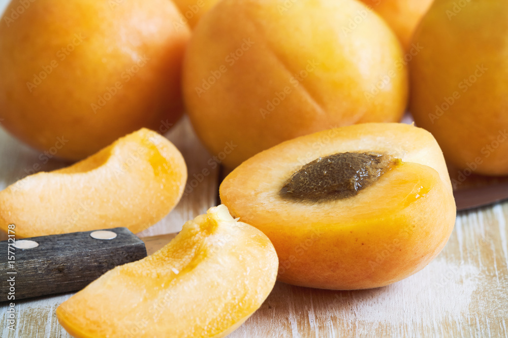 Fresh and ripe raw apricots on wooden background