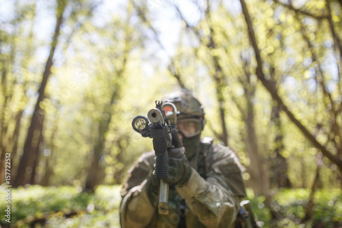 Russian soldier aiming in woods