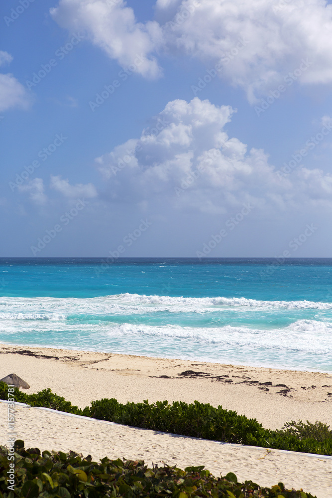 View on the beach. Shore of the Caribbean ocean. Soft sand beach with turquoise water and powerful waves. Tropical wallpaper. View on the beach. Shore of the Caribbean ocean. Soft sand beach with turquoise water and powerful waves. Tropical wallpaper.