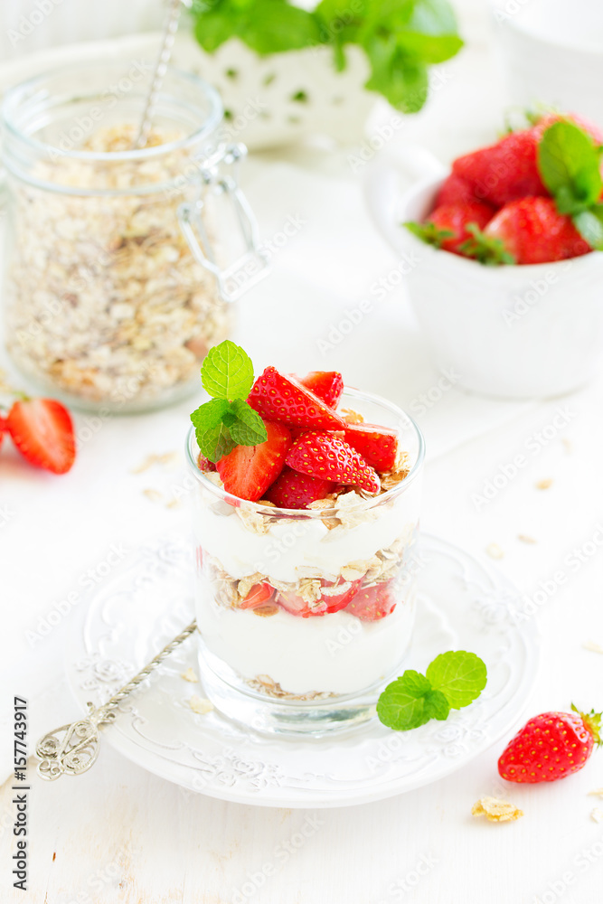 Dessert in a glass with granola, yogurt and strawberries. Useful breakfast. Dessert in a glass with granola, yogurt and strawberries. Useful breakfast.
