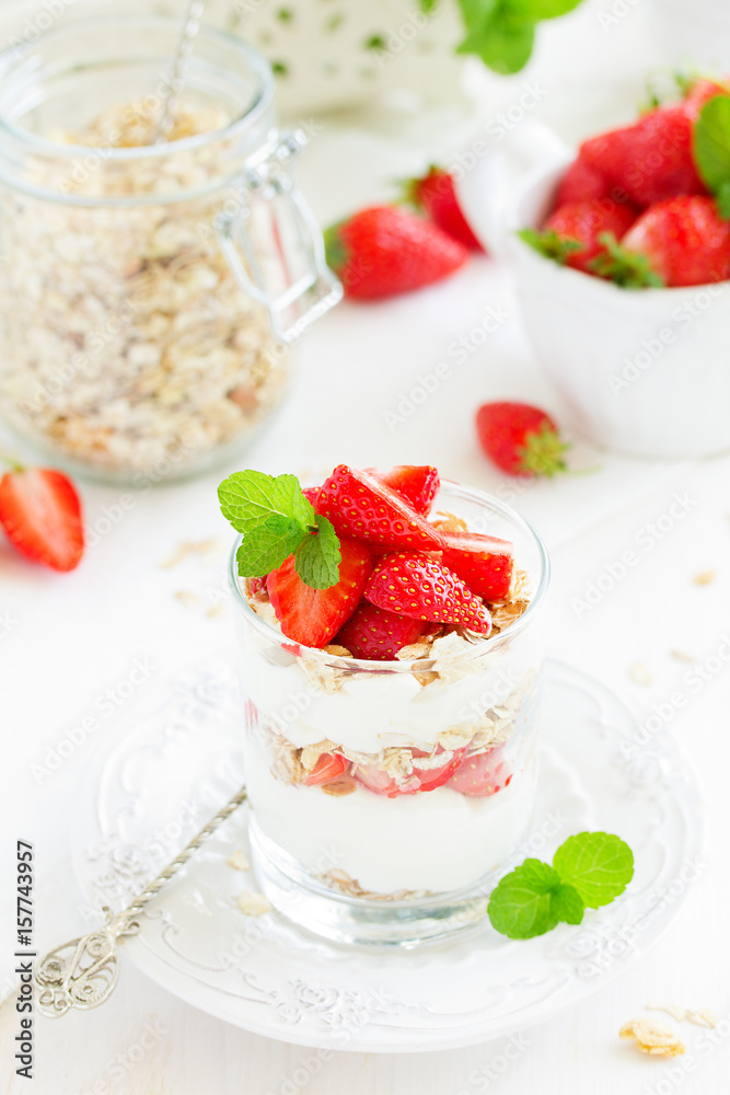 Dessert in a glass with granola, yogurt and strawberries. Useful breakfast. Dessert in a glass with granola, yogurt and strawberries. Useful breakfast.