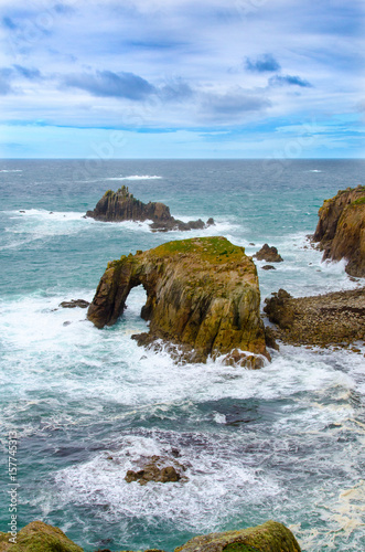 Enys Dodman, a rock arch about 1km south of Lands End, The Armed Knight can be seen beyond. photo