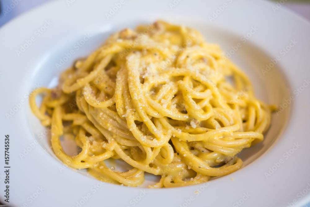 Spaghetti Carbonara served on white plate. Soft Focus.
