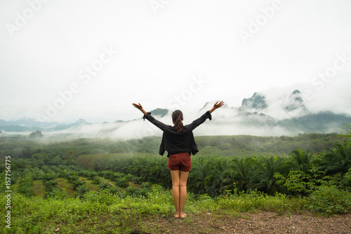 The girl feeling relax on the mountain and fog