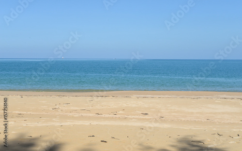 Peaceful sand beach and blue sky, natural background in Thailand