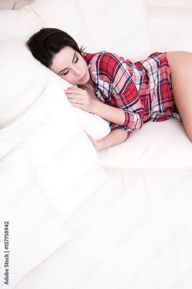 Beautiful young woman lying on the sofa. Beautiful young woman lying on the sofa.