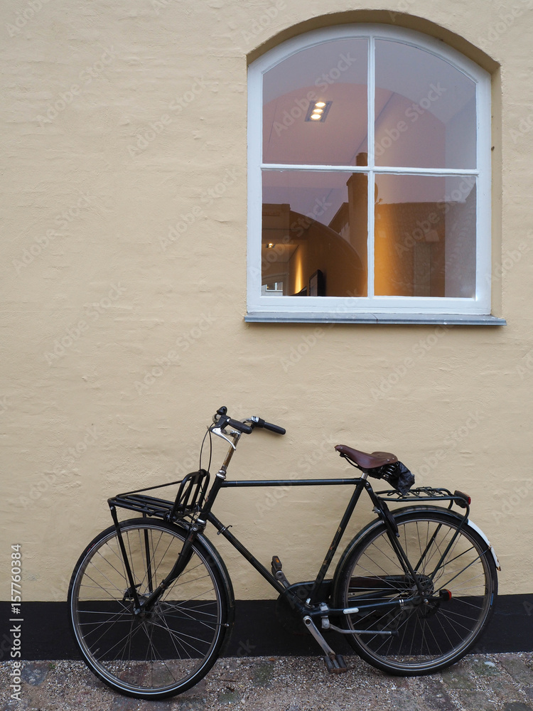 vintage bike beside the yellow wall