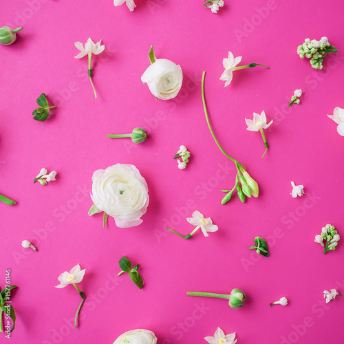 Floral pattern of white flowers and buds on pink background. Flat lay, top view. Beauty background.