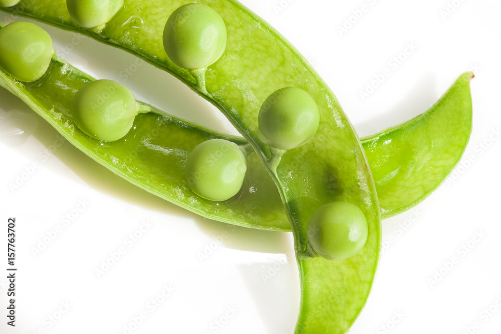 Green peas, close-up on a white background, plate