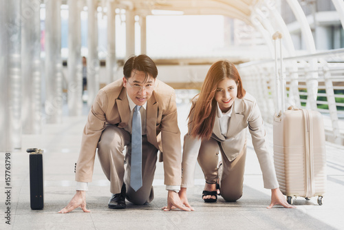 Business people in the ready position to start a race on the street in the city