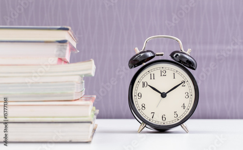 Vintage clock and stack of books